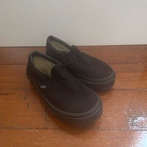 All black slip on vans